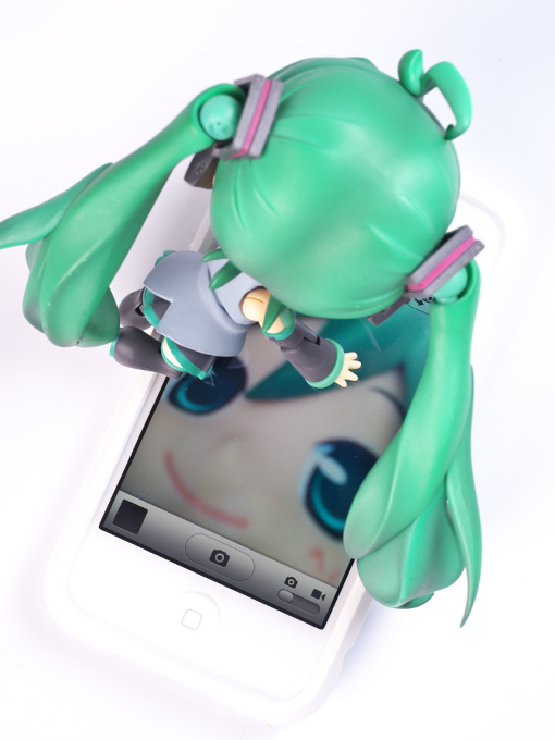 Miku's playing with iPhone.